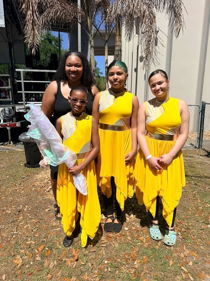 Achieve Stars dancers wearing yellow performance costumes