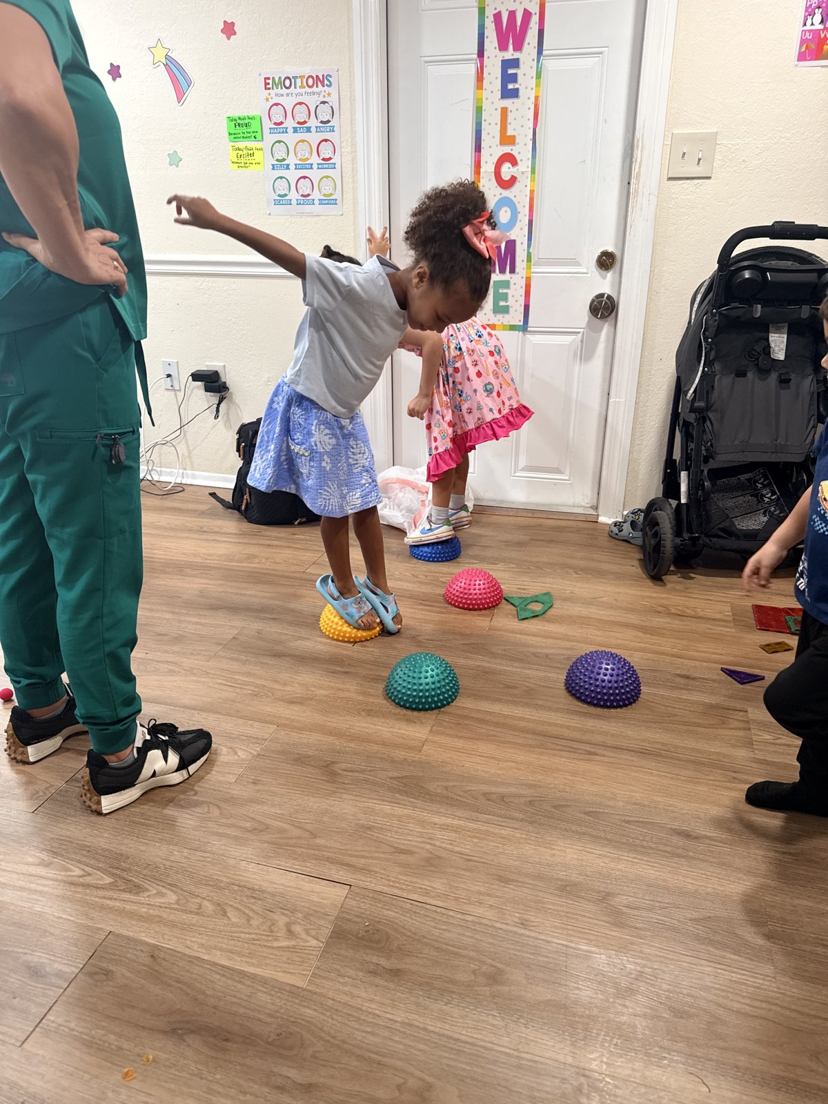 Young learner practicing balance on colorful sensory stepping pods in the classroom