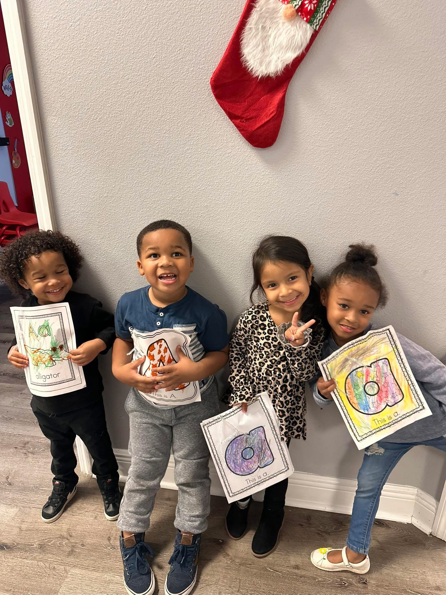 Students proudly holding completed projects